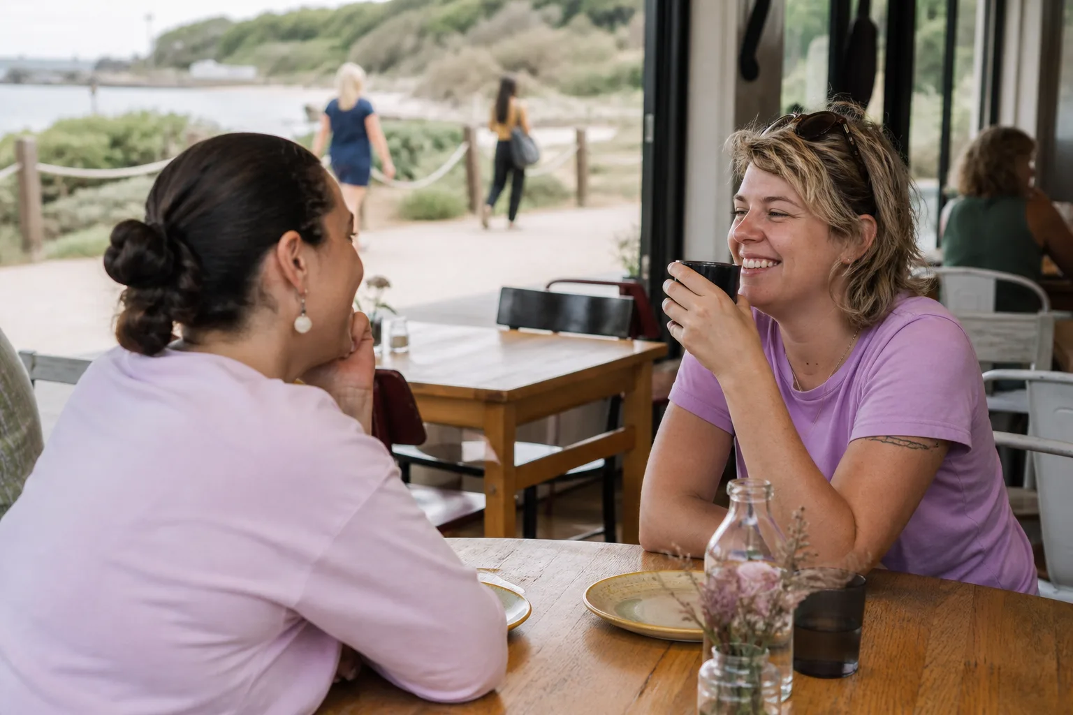 Two women talking beside Torquay harbour